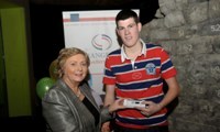 Minister Fitzgerald presents Martin O'Donnell with a raffle prize of an MP3 player