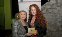 Minister Fitzgerald presents Bridget McDonagh with a raffle prize of a digital camera
